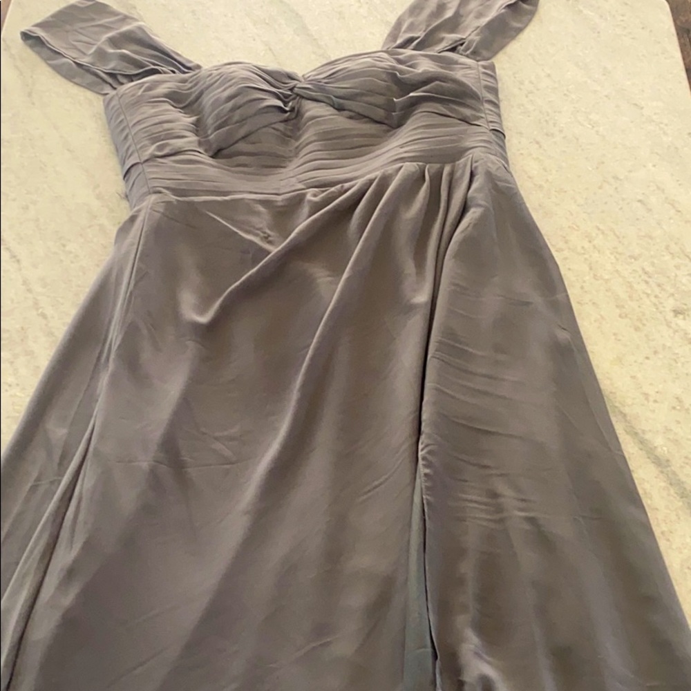 A gray light weight dress, with ruffles at the top